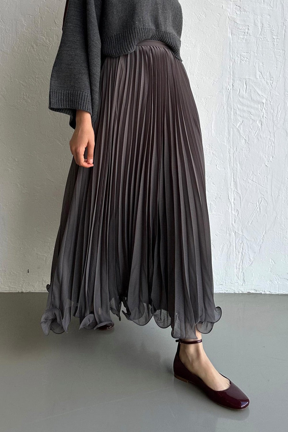 Cherianne.com grey pleated chiffon maxi skirt paired with a dark grey sweater, featuring a flowy silhouette.
