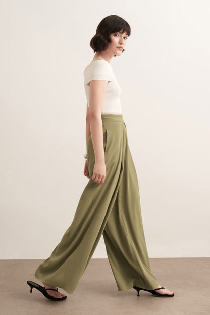 Cherianne.com Leona high-waisted wide-leg olive green trousers with pleated detail worn by a model